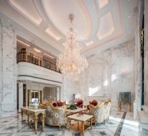 Luxury interior design featuring a grand crystal chandelier, marble walls, and elegant, high-end design.