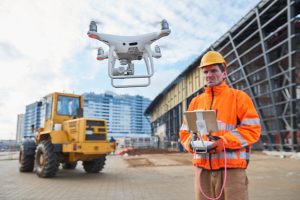 Engineer using a drone for a modern construction site survey