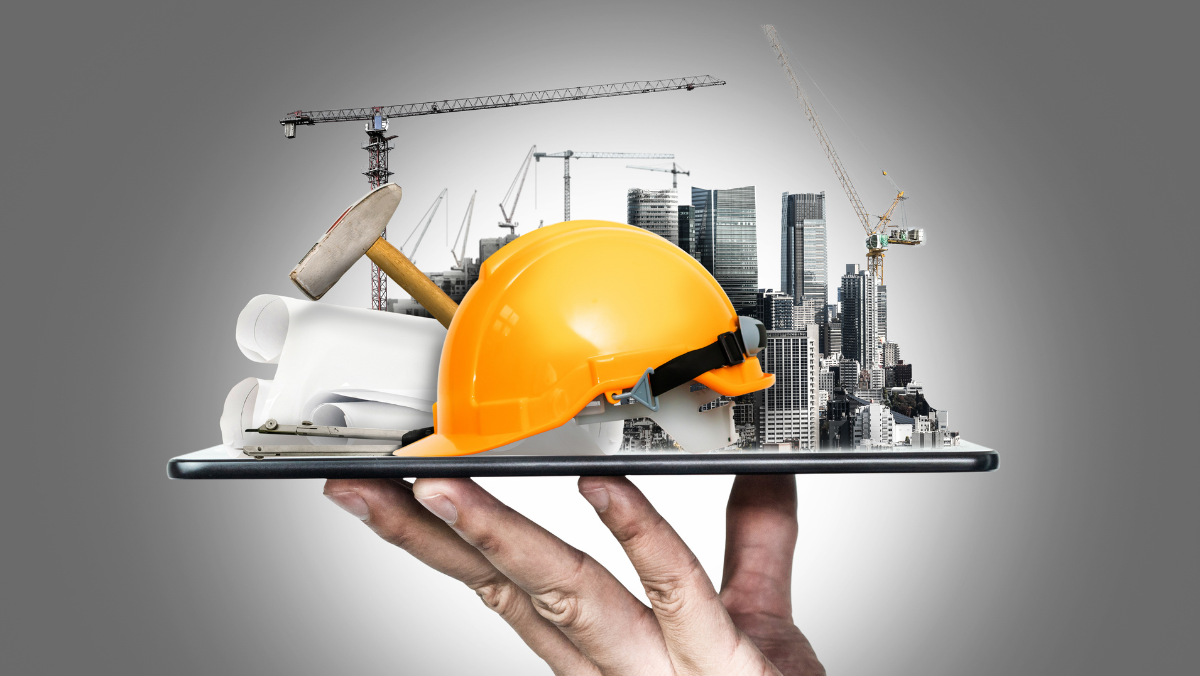 A person holding a tablet displaying a construction site model and a hard hat, representing a turnkey construction service.