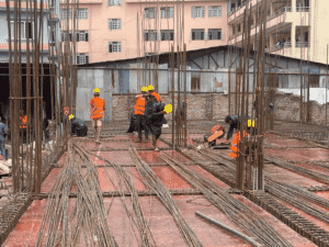 Reinforcement preparation by the ST Builders construction team at a residential building project in Nepal.