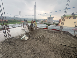 ST Builders residential house construction site in Harisiddhi, Lalitpur during RCC slab casting.