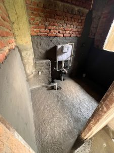 Bathroom waterproofing work in progress at ST Builders residential construction site in Sanepa, Lalitpur.